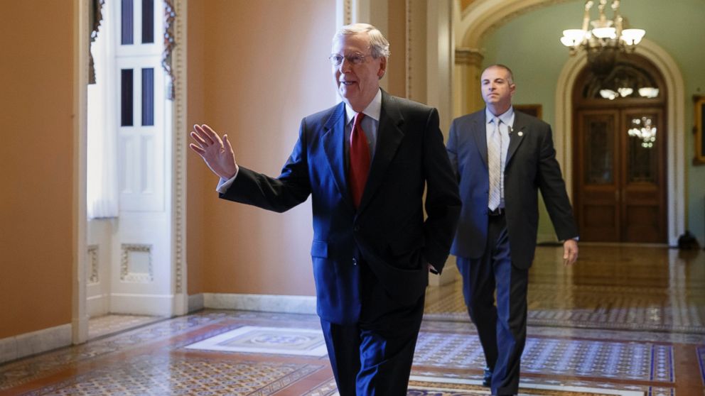 Senate Minority Leader Mitch McConnell of Ky. walks to his office on Capitol Hill in Washington, Nov. 12, 2014, to meet with new GOP senators-elect.