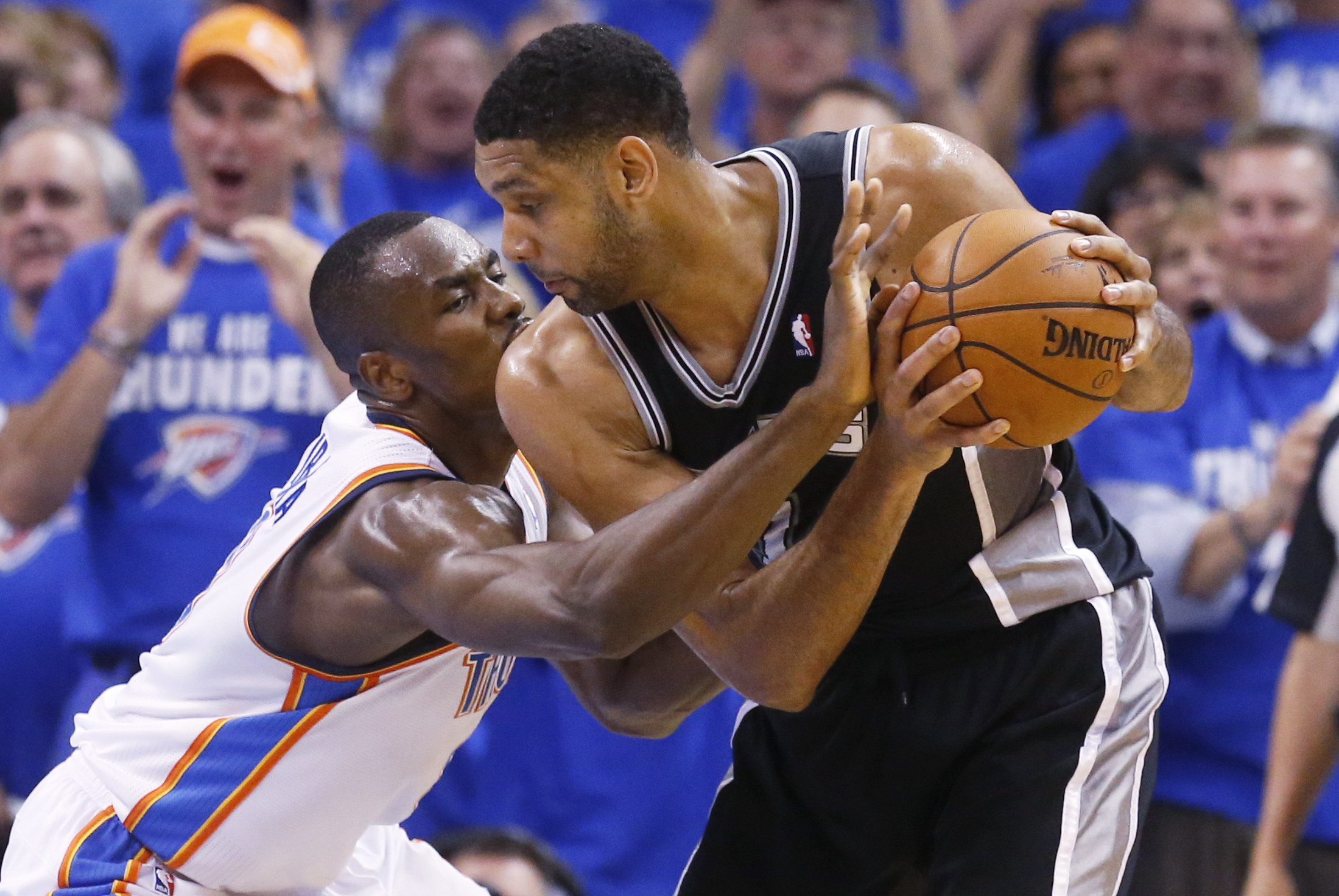 PHOTO: Oklahoma City Thunder forward Serge Ibaka reaches in to try and take the ball away from San Antonio Spurs forward Tim Duncan  at he Western Conference finals NBA basketball playoff series in Oklahoma City, May 27, 2014. 