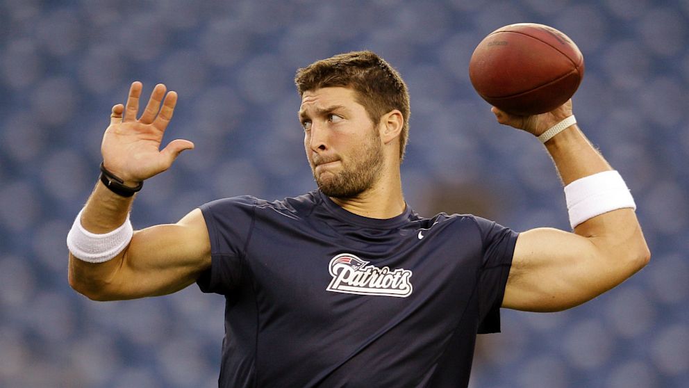 New England Patriots quarterback Tim Tebow warms up before an NFL preseason football game against the New York Giants Thursday, Aug. 29, 2013, in Foxborough, Mass. (AP Photo/Mary Schwalm)