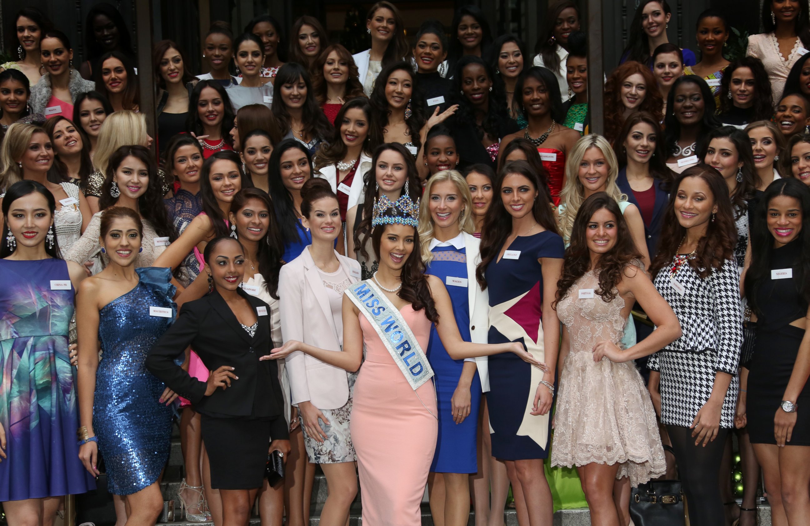 PHOTO: Miss World 2013 Winner Megan Young, centre arms outstretched, poses for photographs with Miss World Contestants in London, Nov. 25, 2014. 
