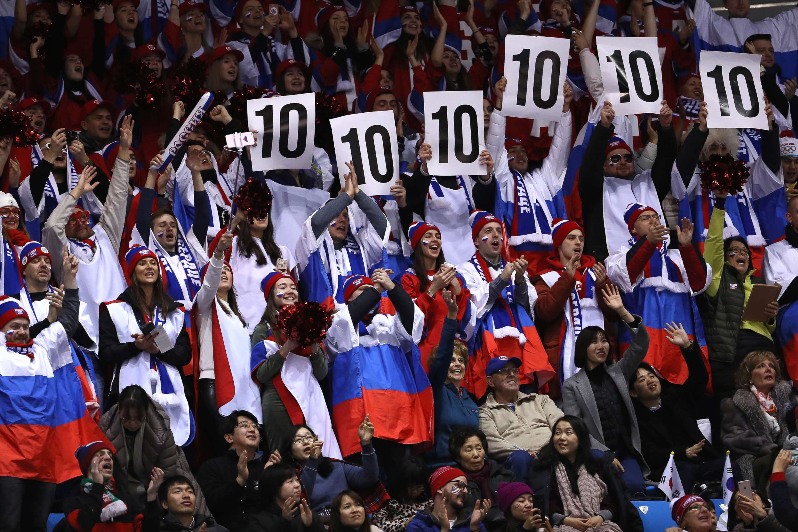 PHOTO: Fans of Evgenia Medvedeva, a skater representing the Olympic Athlete from Russia team, show their scoring figures during the figure skating team event ladies short program, Feb. 11, 2018.