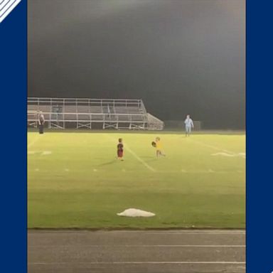 The two kids were on the field ahead of a high school football game in Orlando, Florida. 