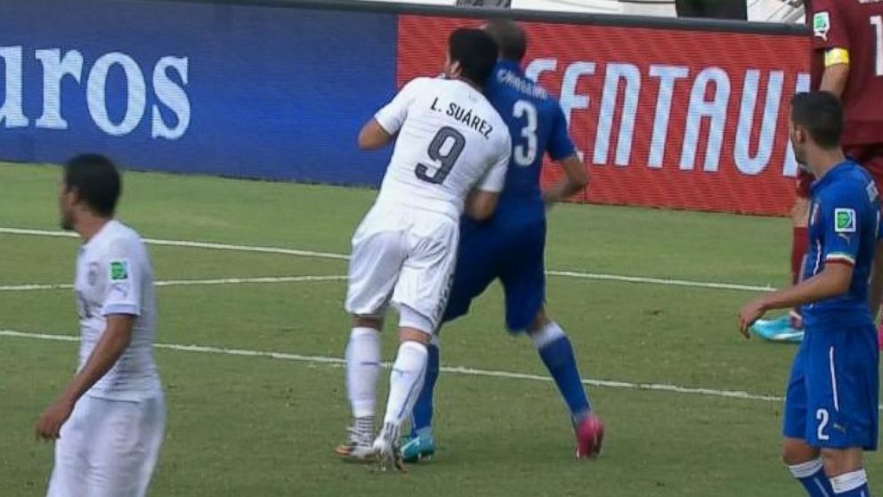 PHOTO: Luis Suarez appears to bite Giorgio Chiellini during the 2014 World Cup on June 24, 2014 in Brazil.