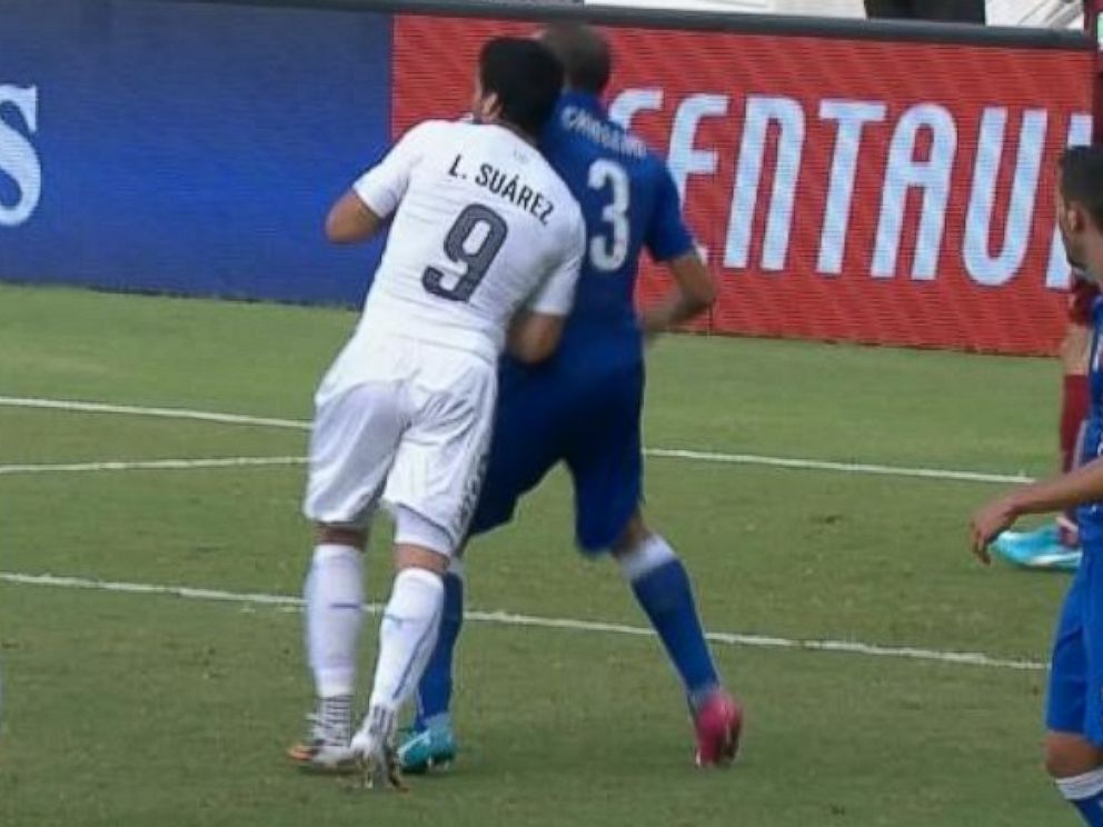 PHOTO: Luis Suarez appears to bite Giorgio Chiellini during the 2014 World Cup on June 24, 2014 in Brazil.