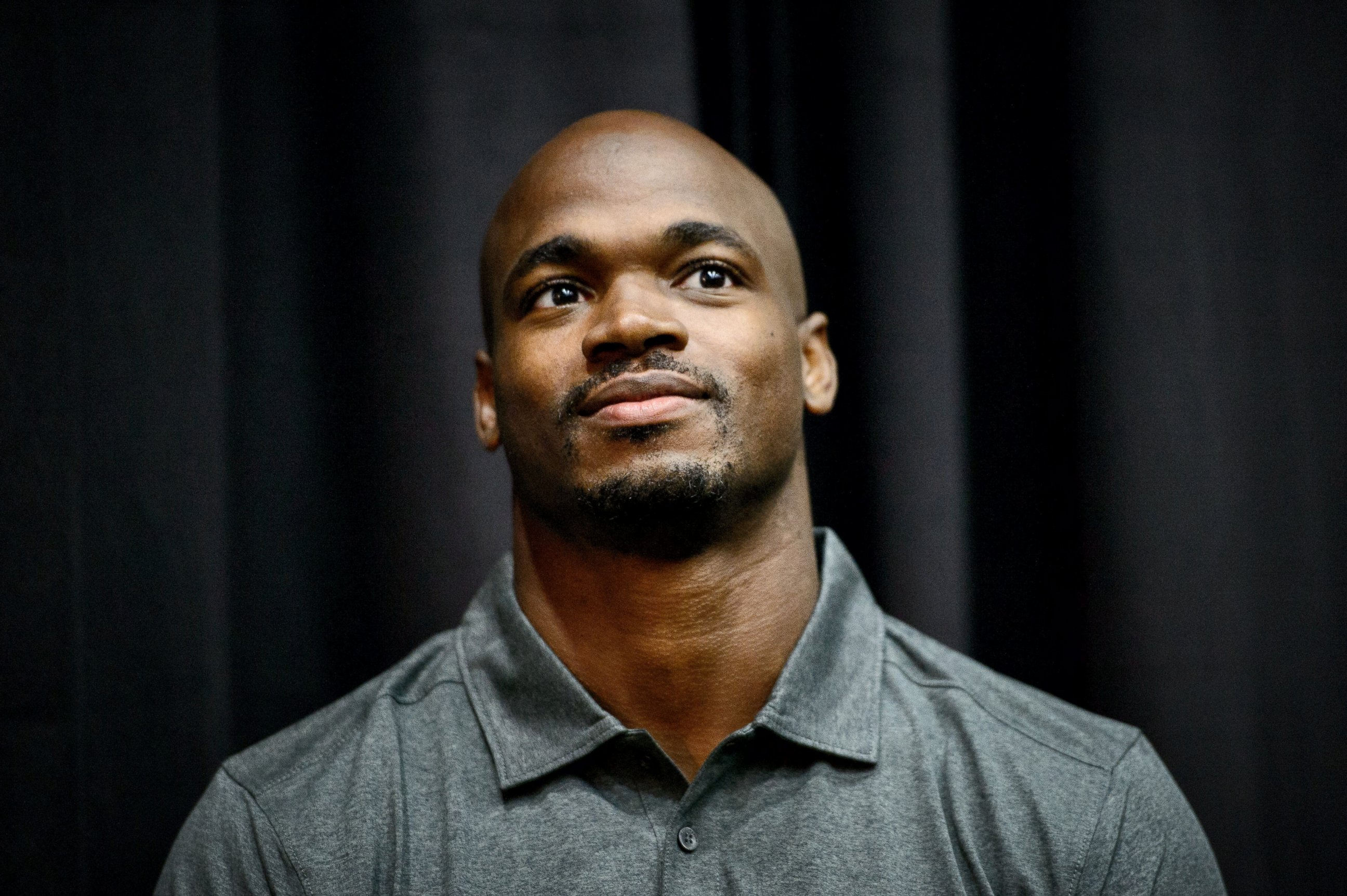Vikings running back Adrian Peterson waits as head coach Mike Zimmer speaks at a news conference in Eden Prairie, Minn., Tuesday June 2, 2015.  Peterson practiced with the Vikings for the first time in nine months on Tuesday.  
