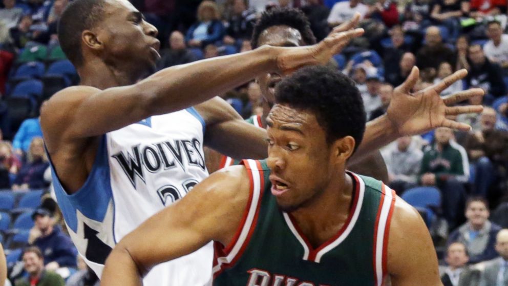 Minnesota Timberwolves' Andrew Wiggins, left, loses the ball to Milwaukee Bucks' Jabari Parker in the first quarter of an NBA basketball game, Nov. 26, 2014, in Minneapolis.