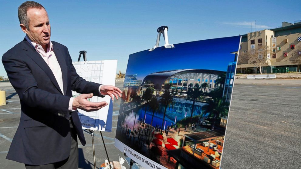 In this Monday, Jan. 5, 2015, file photo, Chris Meany, senior vice president of Hollywood Park Land Company, unveils an architectural rendering of a proposed NFL stadium at Hollywood Park in Inglewood, Calif.