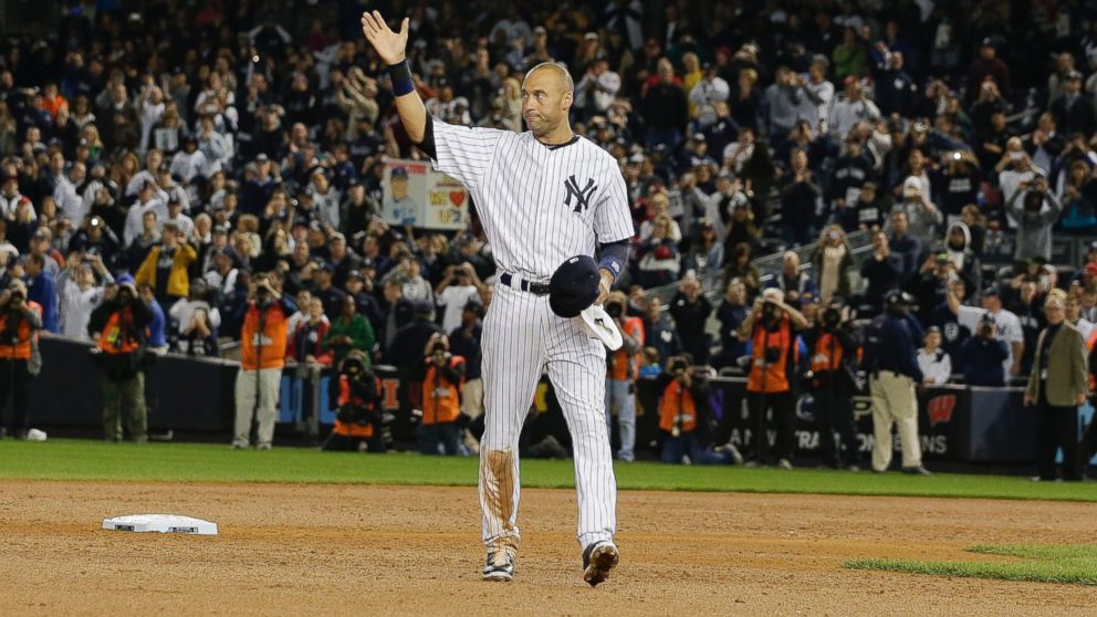 New York Yankees shortstop Derek Jeter waves to fans as he walks around the infield after driving in the winning run against the Baltimore Orioles in the ninth inning of a baseball game, Thursday, Sept. 25, 2014, in New York. 