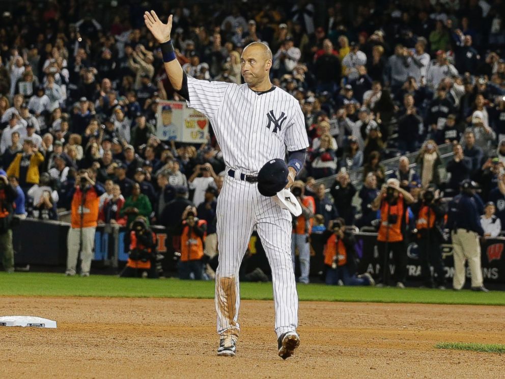 New York Yankees shortstop Derek Jeter waves to fans as he walks around the infield after driving in the winning run against the Baltimore Orioles in the ninth inning of a baseball game, Thursday, Sept. 25, 2014, in New York.