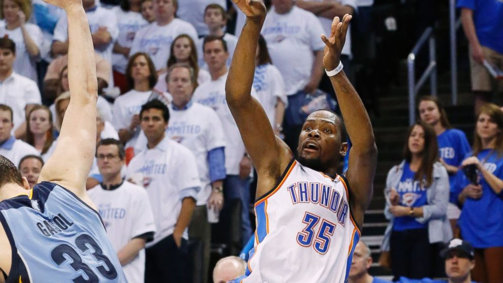 Oklahoma City Thunder forward Kevin Durant releases an off-balance shot after being fouled by Memphis Grizzlies center Marc Gasol during an NBA playoff game, April 21, 2014.