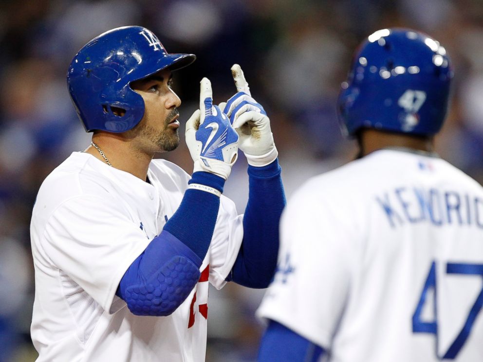 PHOTO: Los Angeles Dodgers' Adrian Gonzalez, left, points to the sky after hitting a home run against the San Diego Padres during the first inning of a baseball game in Los Angeles, April 8, 2015.