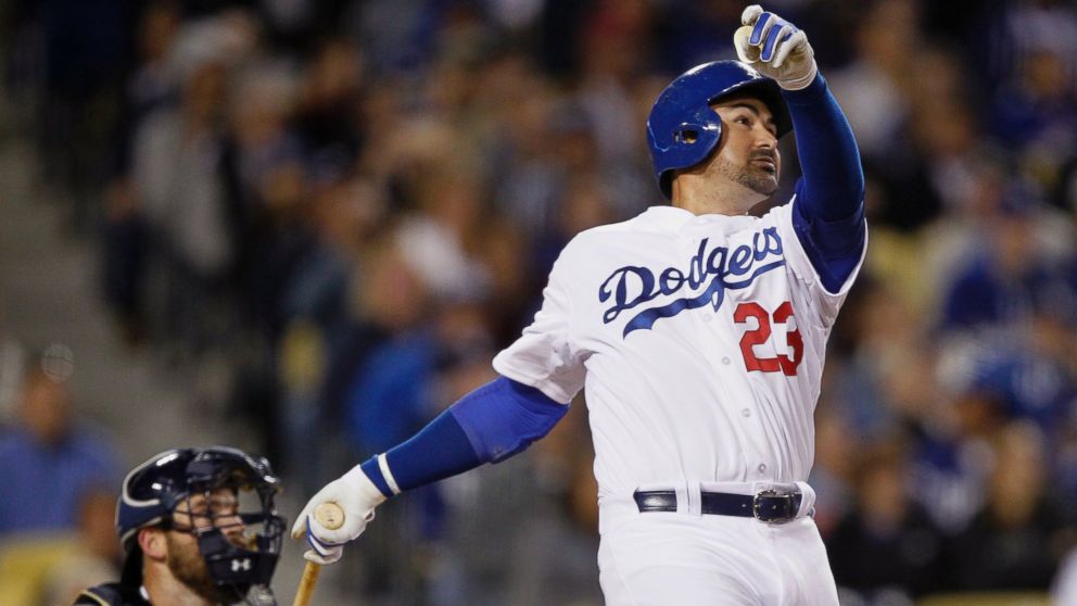 Los Angeles Dodgers' Adrian Gonzalez watches his solo home run in front of San Diego Padres catcher Derek Norris during the fifth inning of a baseball game in Los Angeles, April 8, 2015.