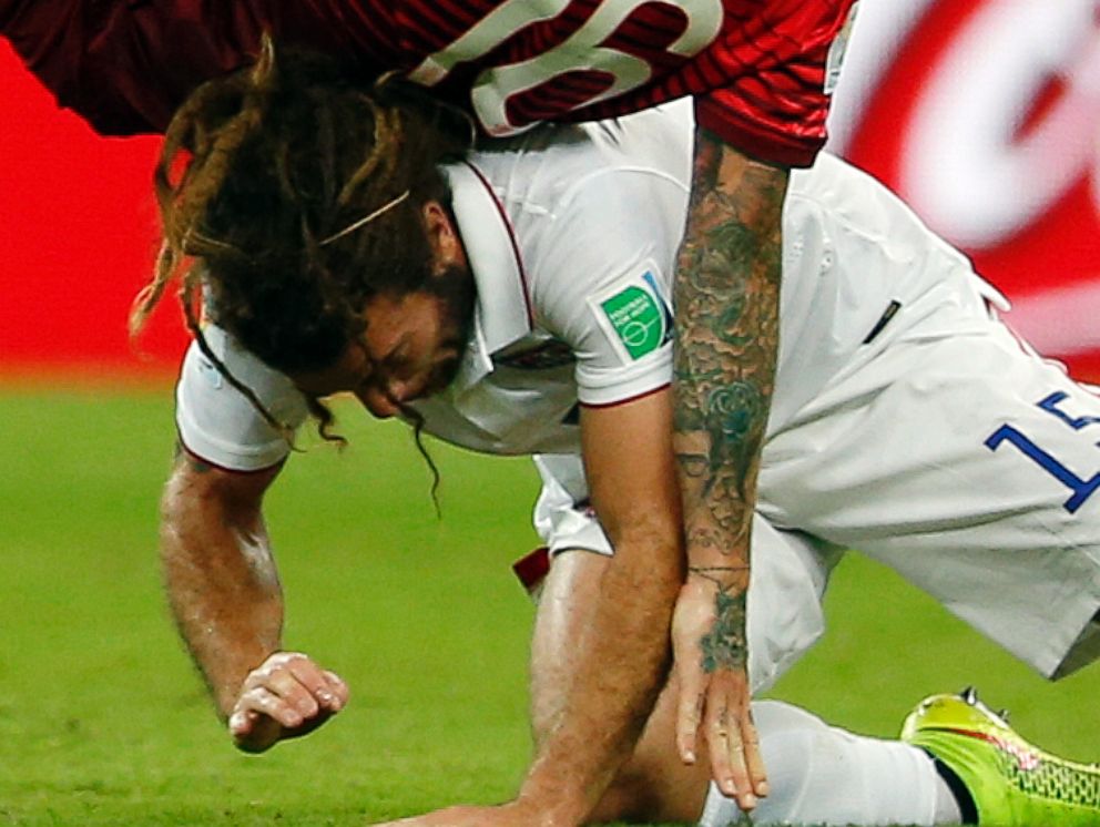 PHOTO: Portugal's Raul Meireles falls on top of United States' Kyle Beckerman during the group G World Cup soccer match between the United States and Portugal at the Arena da Amazonia in Manaus, Brazil, Sunday, June 22, 2014.