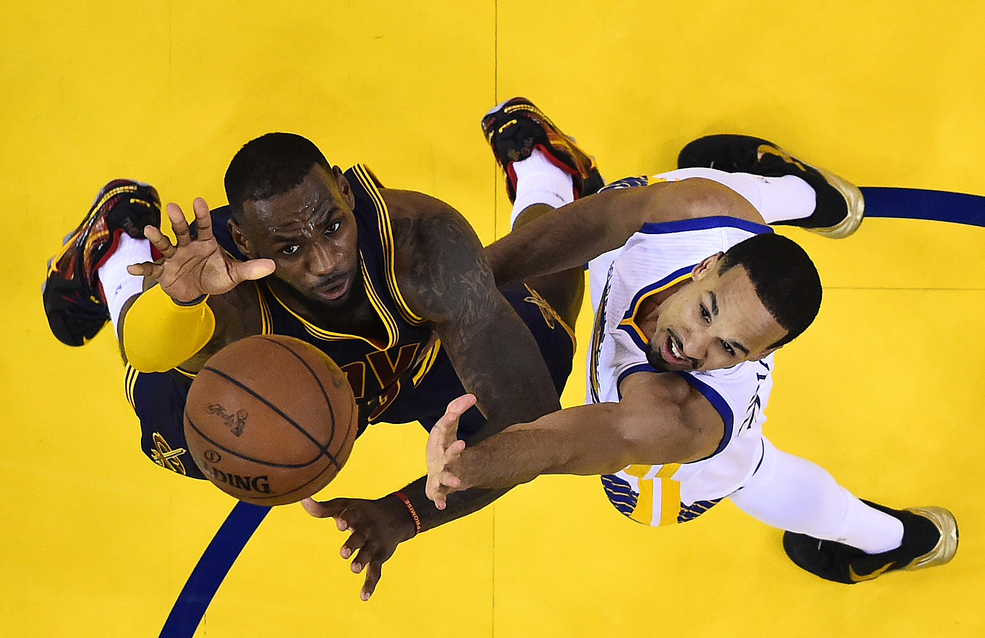 PHOTO: Cleveland Cavaliers forward LeBron James, left, reaches for the ball next to Golden State Warriors guard Shaun Livingston during the second half of Game 5 of the NBA Finals in Oakland, Calif., June 14, 2015.
