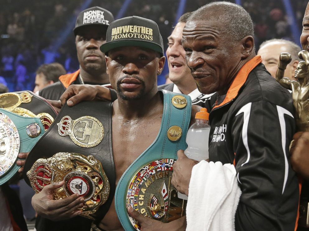 PHOTO: Floyd Mayweather Jr., left, poses with his champion's belts and his father, head trainer Floyd Mayweather Sr., after his victory over Manny Pacquiao, from the Philippines,  in their welterweight title fight on Saturday, May 2, 2015 in Las Vegas. 