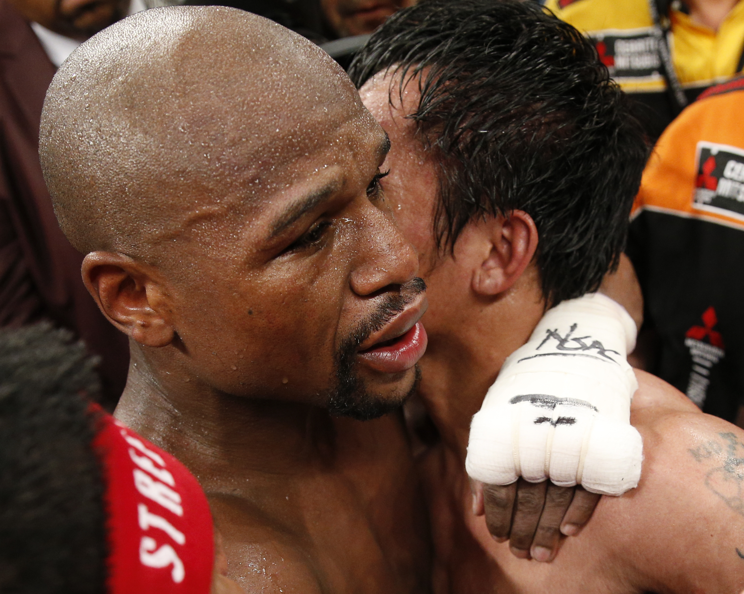 PHOTO:Floyd Mayweather Jr., left, and Manny Pacquiao, from the Philippines, embrace in the ring at the finish of their welterweight title fight on Saturday, May 2, 2015 in Las Vegas.  