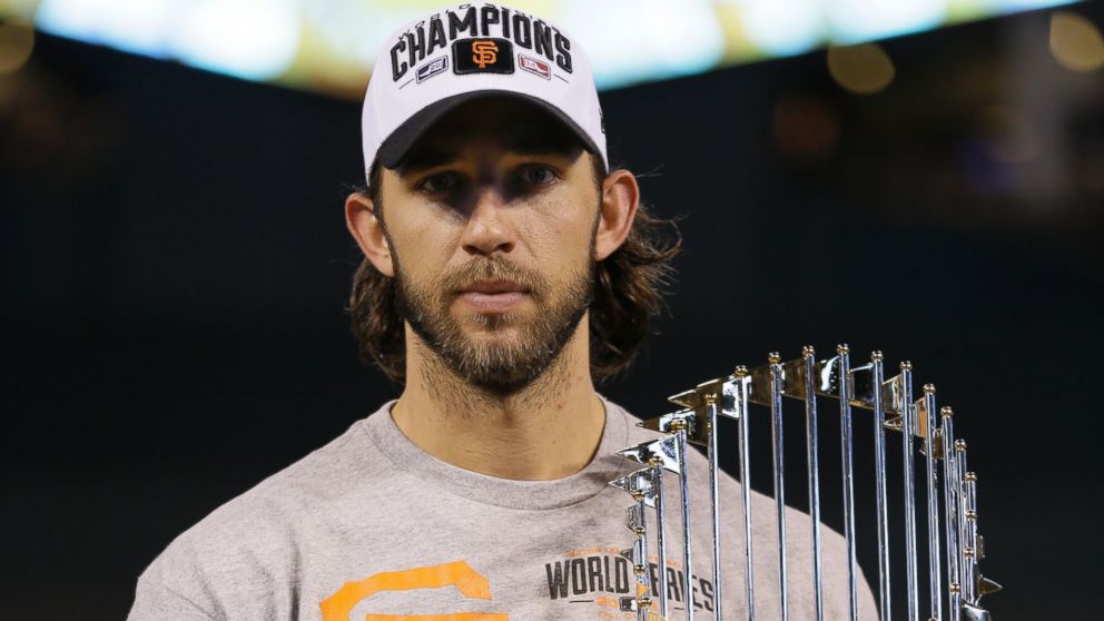 San Francisco Giants pitcher Madison Bumgarner holds the World Series trophy after Game 7 of baseball's World Series Thursday, Oct. 30, 2014, in Kansas City, Mo. The Giants defeated the Kansas City Royals 3-2 to win the series.