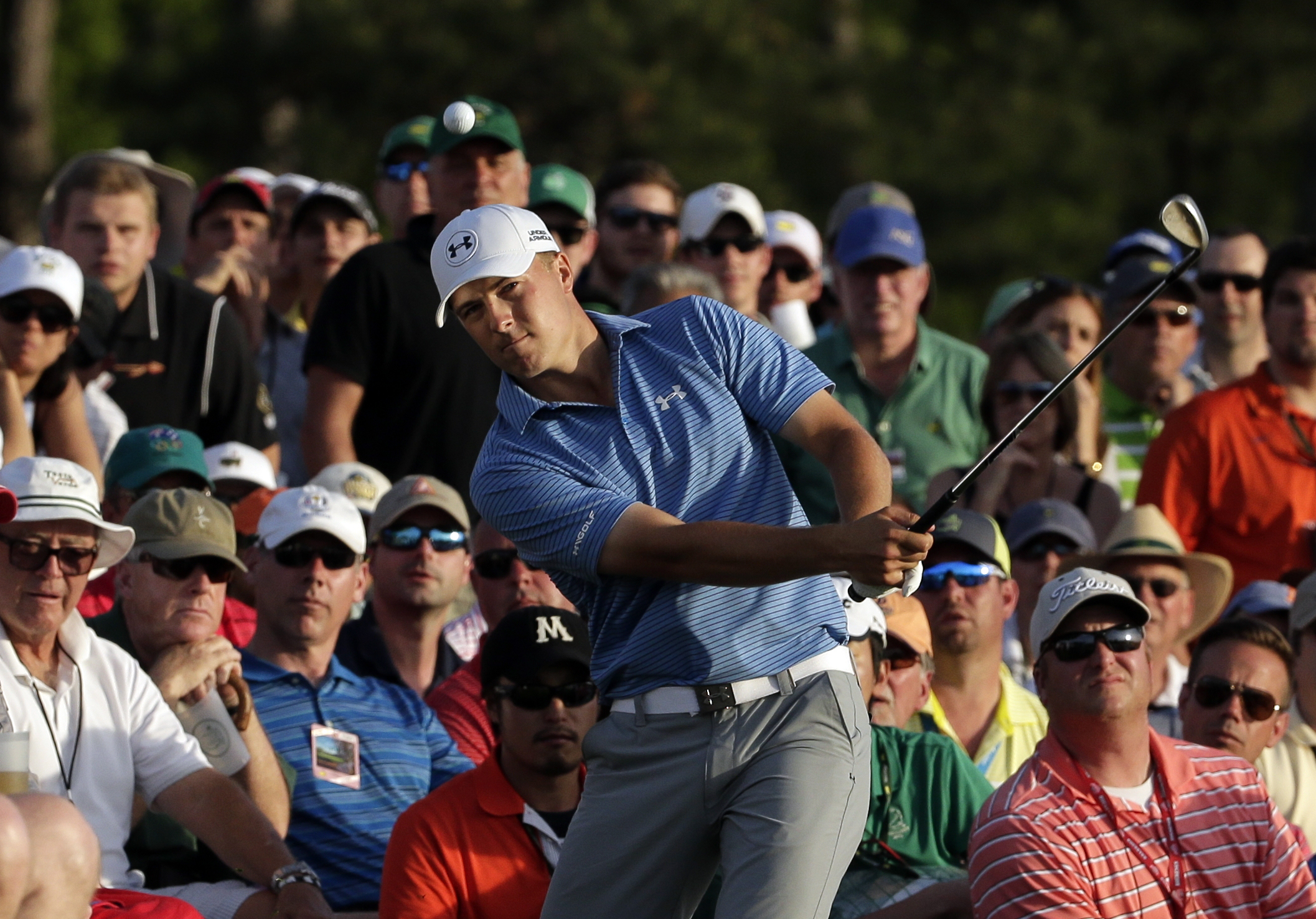 Jordan Spieth hits out of the gallery on the 18th hole during the third round of the Masters golf tournament Saturday, April 11, 2015, in Augusta, Ga.