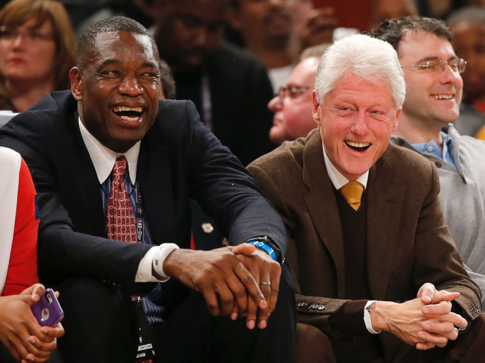 PHOTO: Former President Bill Clinton, right, sits with former NBA basketball player Dikembe Mutombo during the first half of the NBA All-Star game, Feb. 15, 2015, in New York.