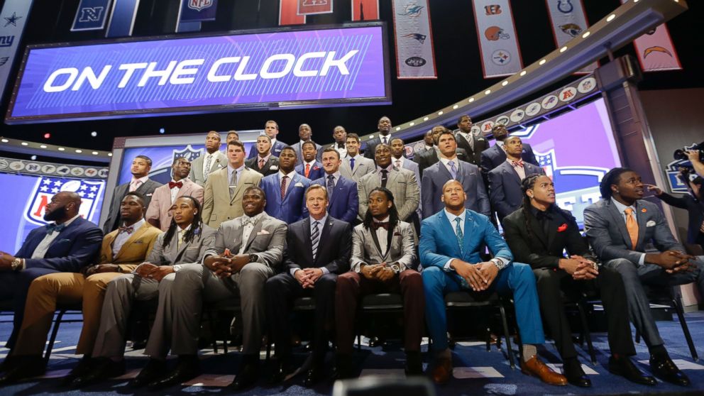 NFL draftees pose with commissioner Roger Goodell at the start of the 2014 NFL Draft, Thursday, May 8, 2014, in New York.