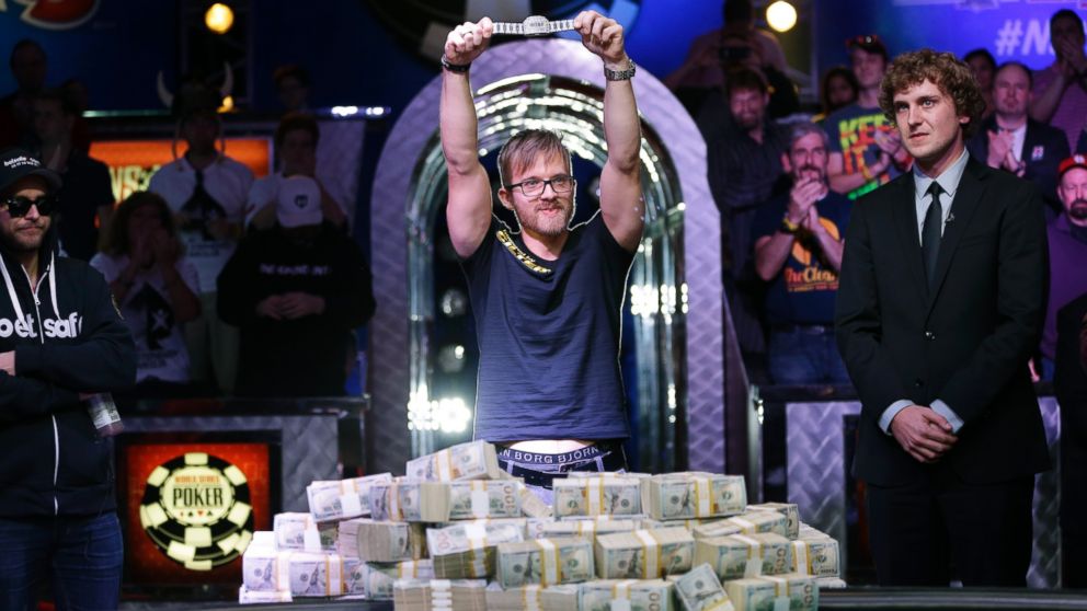 Martin Jacobson holds up the World Series of Poker main event bracelet after winning the tournament and its $10 million prize, Nov. 11, 2014, in Las Vegas.