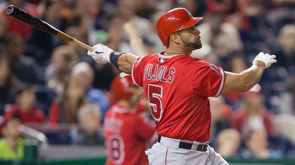 PHOTO: Los Angeles Angels first baseman Albert Pujols watches the ball after connecting for his 500th career home run,April 22, 2014.