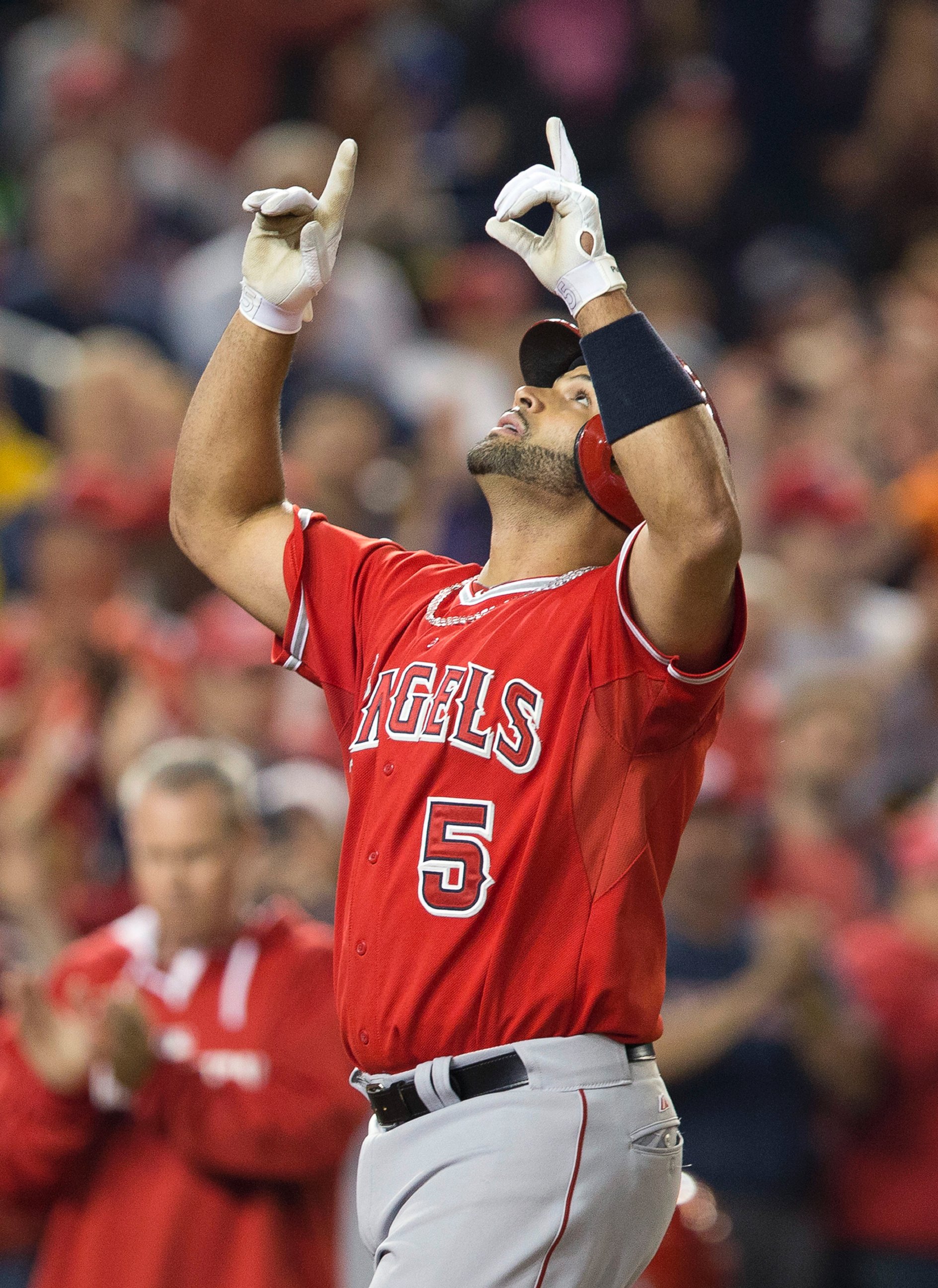 PHOTO: Albert Pujols points upward as he crosses home plate after hitting his 500th career home run, April 22, 2014.