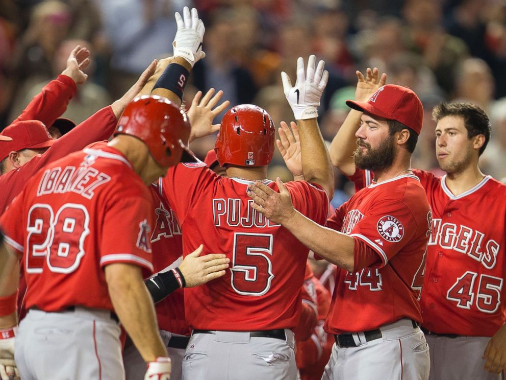 PHOTO: Teammates greet Albert Pujols after his 500th career home run, April 22, 2014.