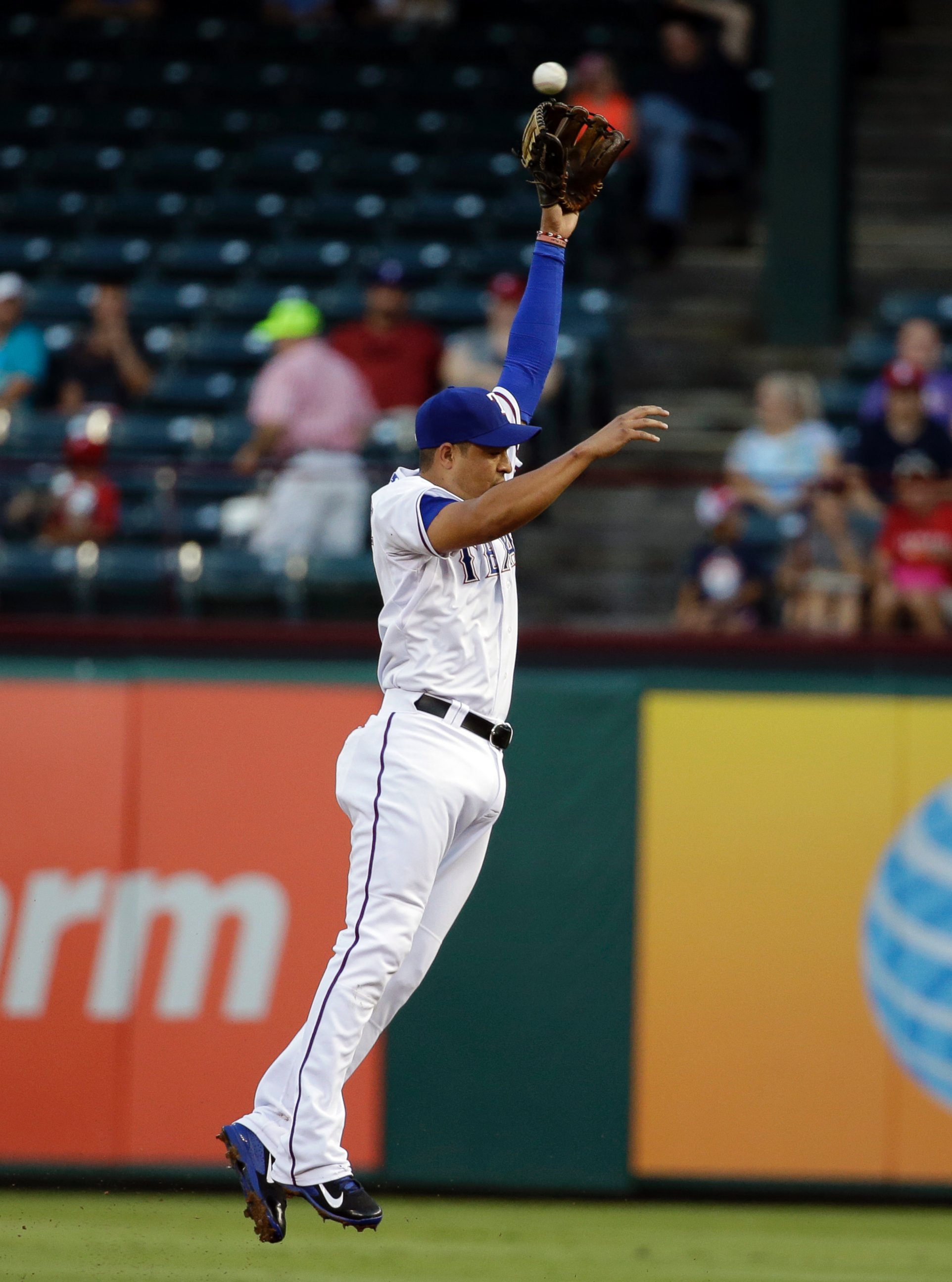 PHOTO: Texas Rangers second baseman Guilder Rodriguez leaps but is unable to grab a single by Los Angeles Angels' Howie Kendrick, Sept. 9, 2014, in Arlington, Texas.