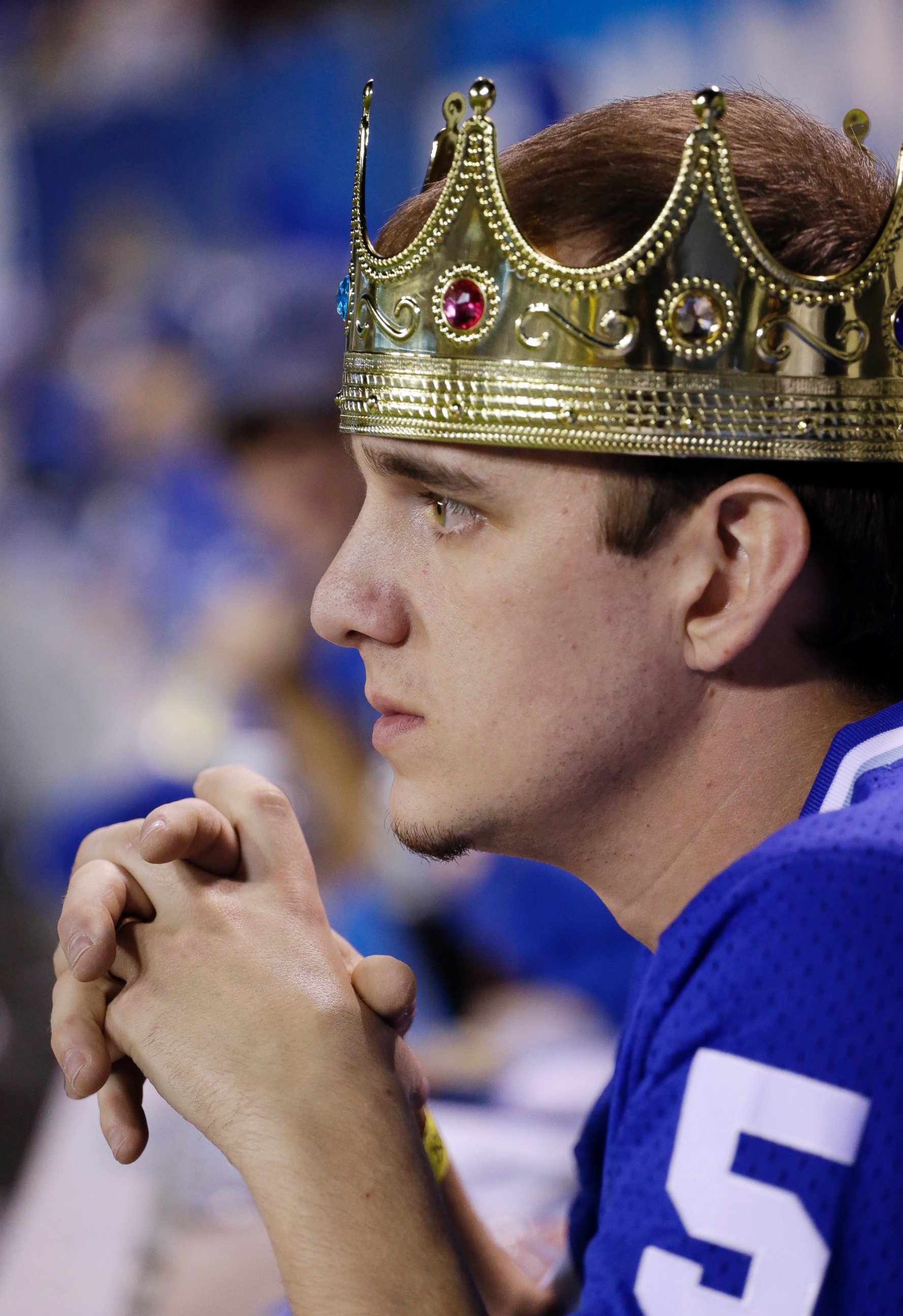 A Kansas City Royals fan watches during the ninth inning of Game 1 of baseball's World Series against the San Francisco Giants, Oct. 21, 2014, in Kansas City, Mo.