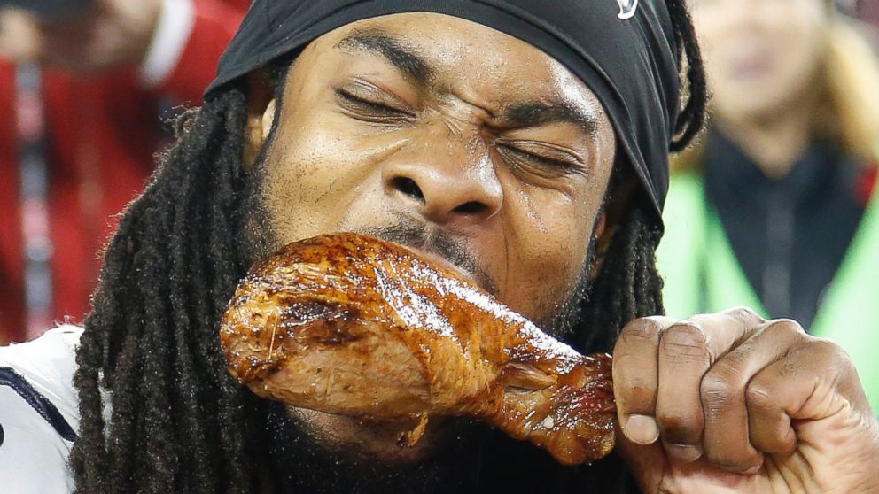 Seattle Seahawks cornerback Richard Sherman takes a bite out of a turkey leg after the Seahawks beat the San Francisco 49ers 19-3 in an NFL football game in Santa Clara, Calif., Nov. 27, 2014.