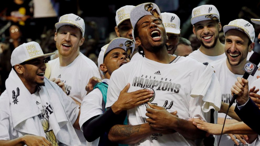 The San Antonio Spurs celebrate with the Larry O'Brien trophy after  defeating the Miami Heat following game 5 of the NBA Finals at the AT&T  Center at the AT&T Center in San