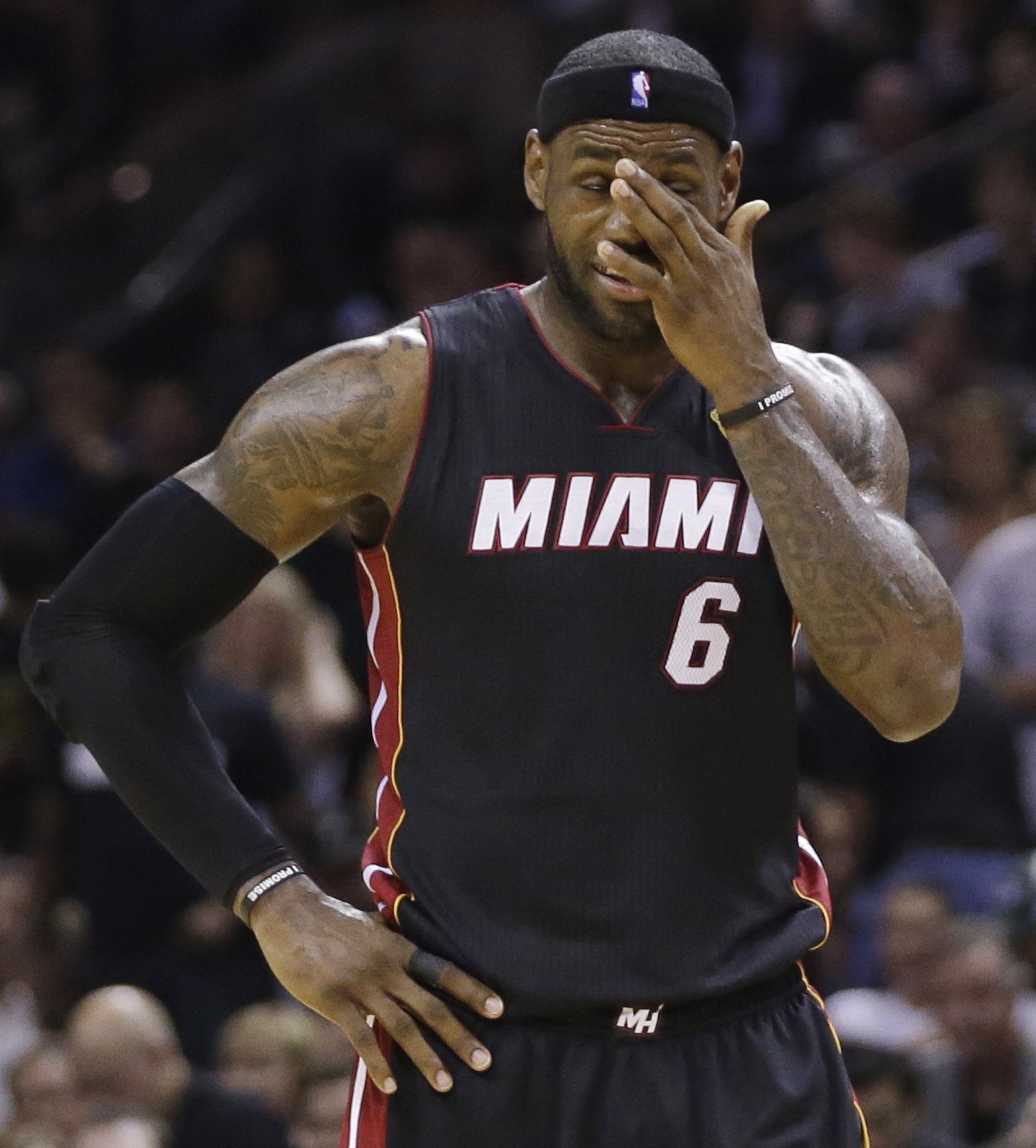 PHOTO: Miami Heat forward LeBron James pauses between plays against the San Antonio Spurs during the second half in Game 5 of the NBA basketball finals, June 15, 2014, in San Antonio.