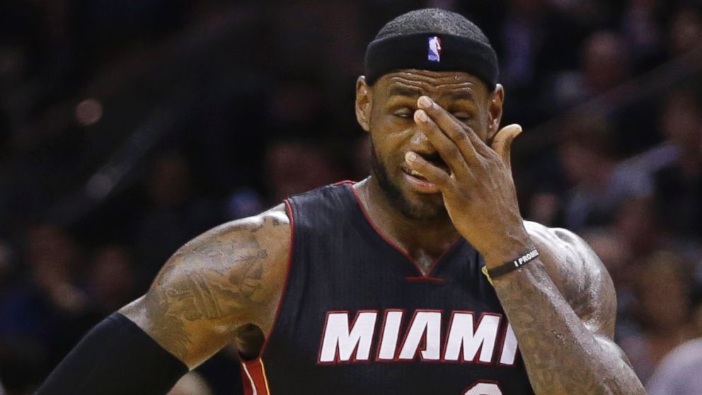 PHOTO: Miami Heat forward LeBron James pauses between plays against the San Antonio Spurs during the second half in Game 5 of the NBA basketball finals, June 15, 2014, in San Antonio.