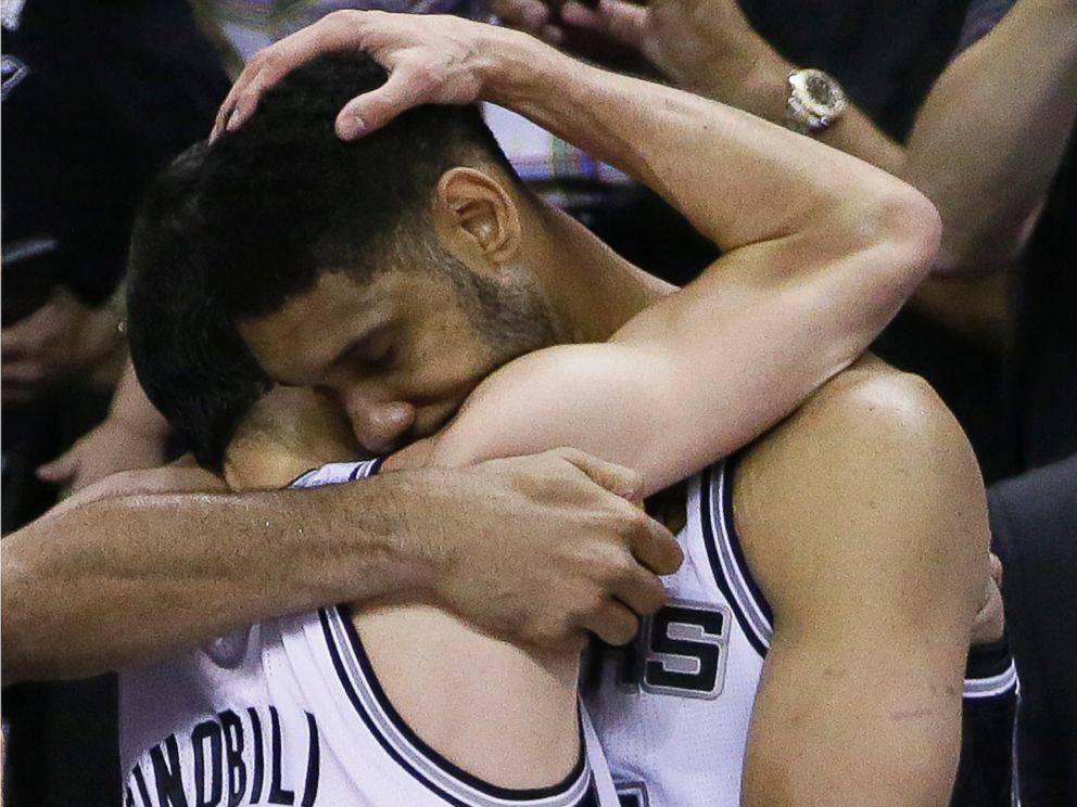 PHOTO: San Antonio Spurs guard Manu Ginobili, left, and forward Tim Duncan embrace in the final moments of Game 5 of the NBA basketball finals against the Miami Heat, June 15, 2014, in San Antonio.