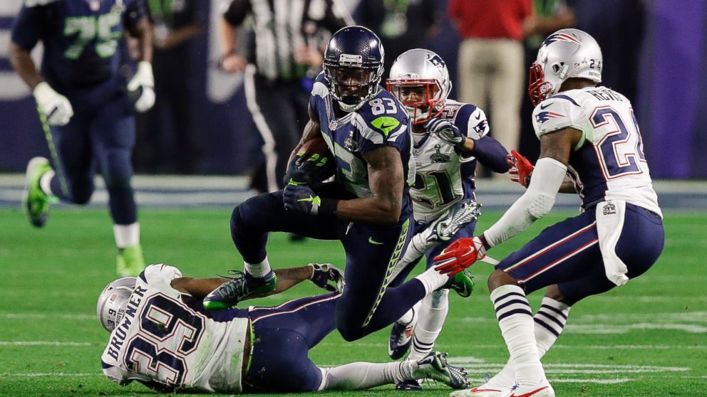 Seattle Seahawks wide receiver Ricardo Lockette   leaps over New England Patriots wide receiver Greg Orton   during the second half of NFL Super Bowl XLIX football game, Feb. 1, 2015, in Glendale, Ariz.