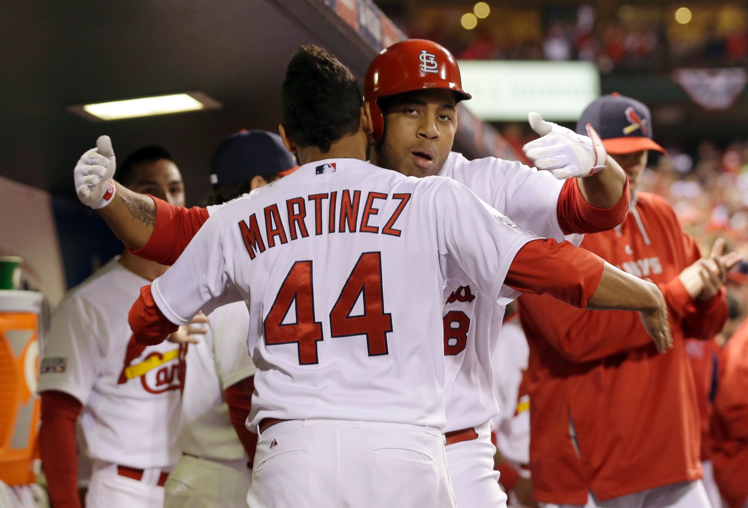 St. Louis Cardinals' Oscar Taveras is congratulated by Carlos Martinez (44) after hitting a home run during the seventh inning in Game 2 of the National League baseball championship series against the San Francisco Giants Sunday, Oct. 12, 2014.
