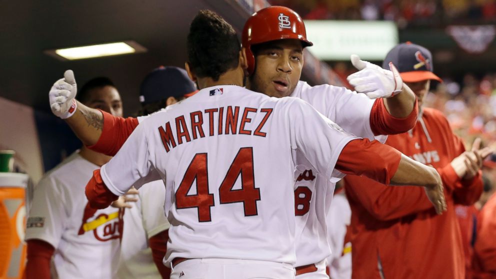St. Louis Cardinals' Oscar Taveras is congratulated by Carlos Martinez (44) after hitting a home run during the seventh inning in Game 2 of the National League baseball championship series against the San Francisco Giants Sunday, Oct. 12, 2014.