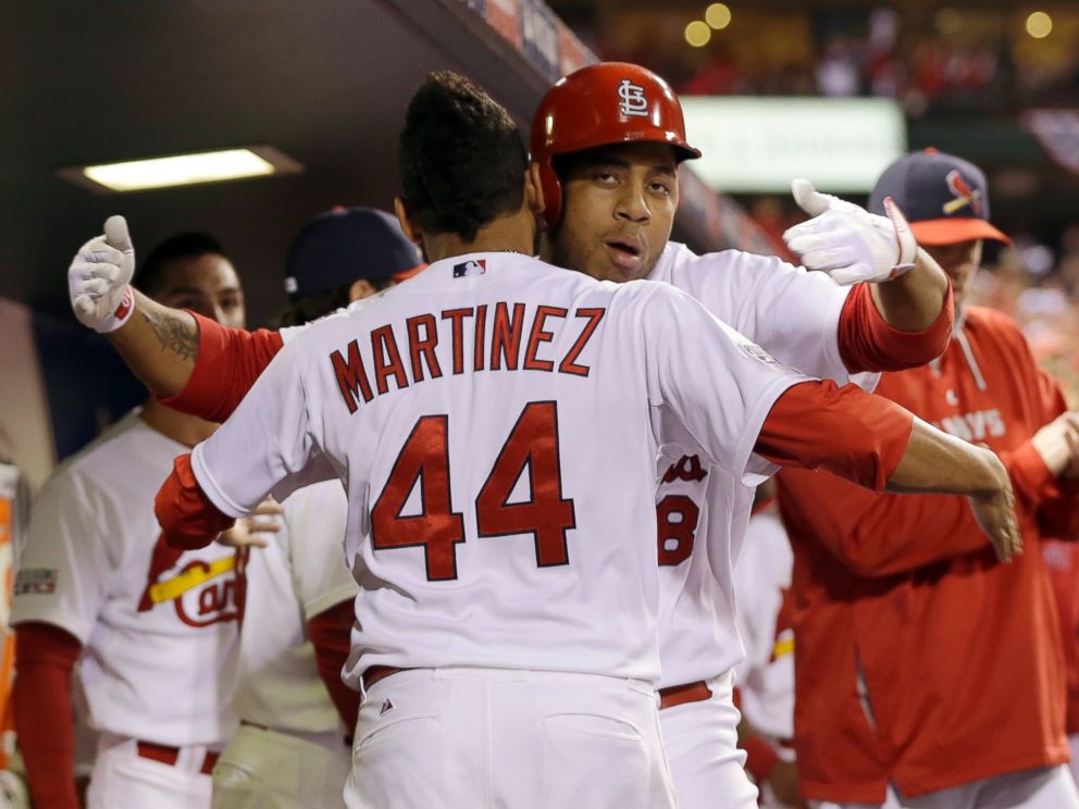 St. Louis Cardinals Oscar Taveras is congratulated by Carlos Martinez (44) after hitting a home run during the seventh inning in Game 2 of the National League baseball championship series against the San Francisco Giants Sunday, Oct. 12, 2014.