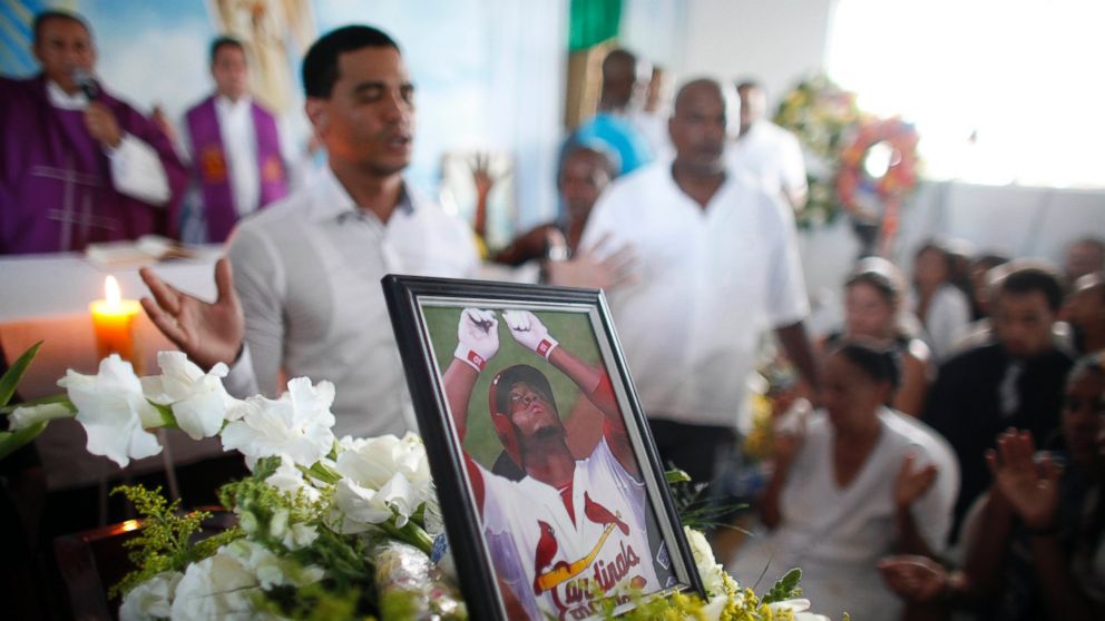 A photo of St. Louis Cardinals outfielder Oscar Taveras stands on top of the coffin containing his body during his funeral in Sosua, Dominican Republic, Oct. 28, 2014.