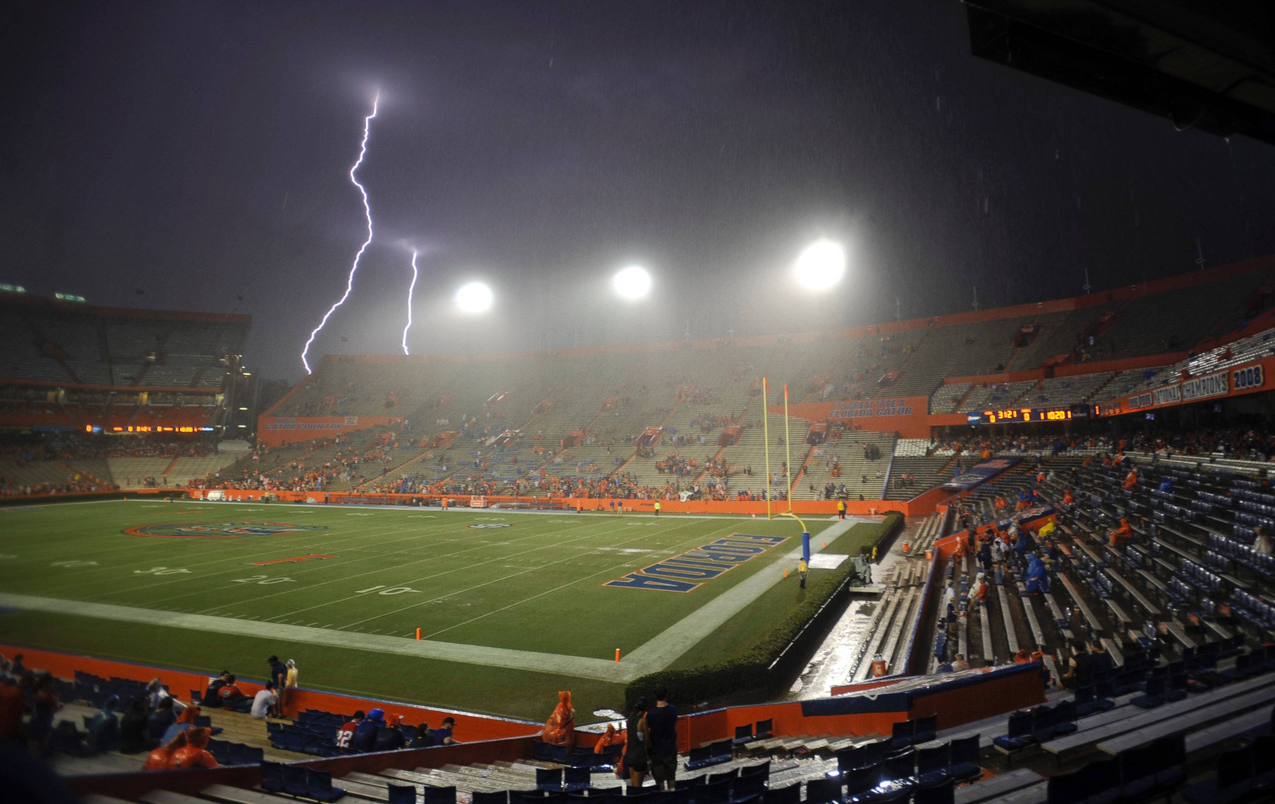 Lightning strikes near Ben Hill Griffin Stadium at Florida Field during a weather delay before an NCAA college football game between Florida and Idaho in Gainesville, Fla., Saturday, Aug. 30, 2014. 