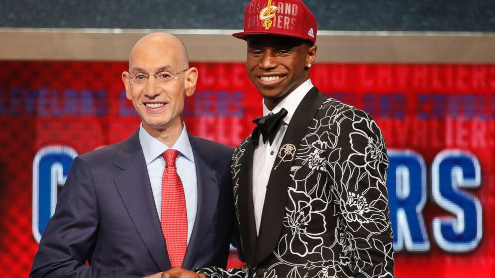 NBA Commissioner Adam Silver, left, congratulates Andrew Wiggins of Kansas who was selected by the Cleveland Cavaliers as the number one pick in the 2014 NBA draft, June 26, 2014, in New York.