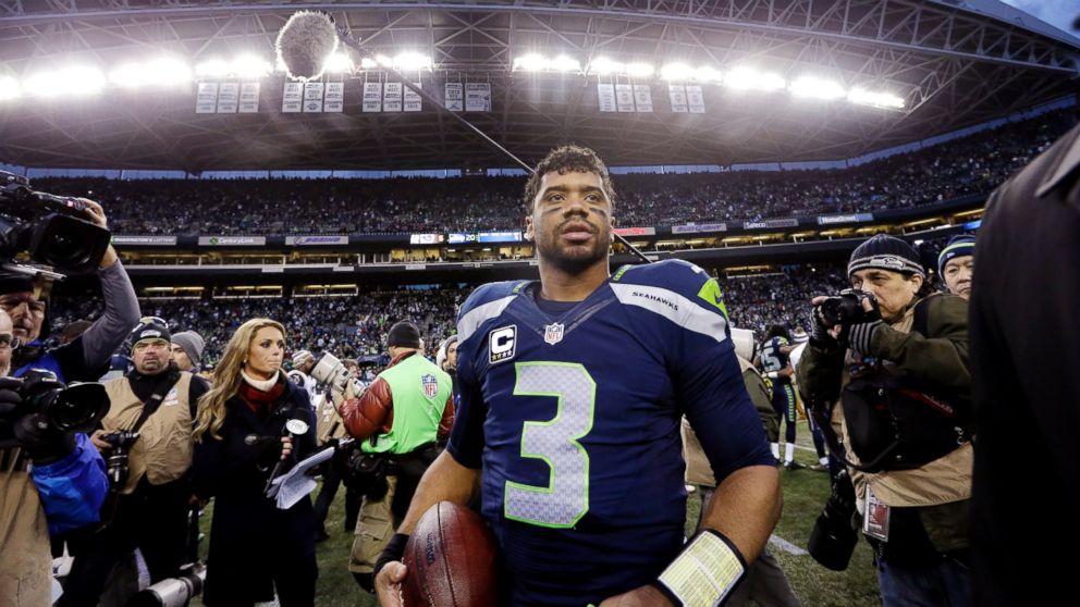 Seattle Seahawks quarterback Russell Wilson walks off the CenturyLink Field after his team defeated the St. Louis Rams in an NFL football game, Dec. 28, 2014, in Seattle.