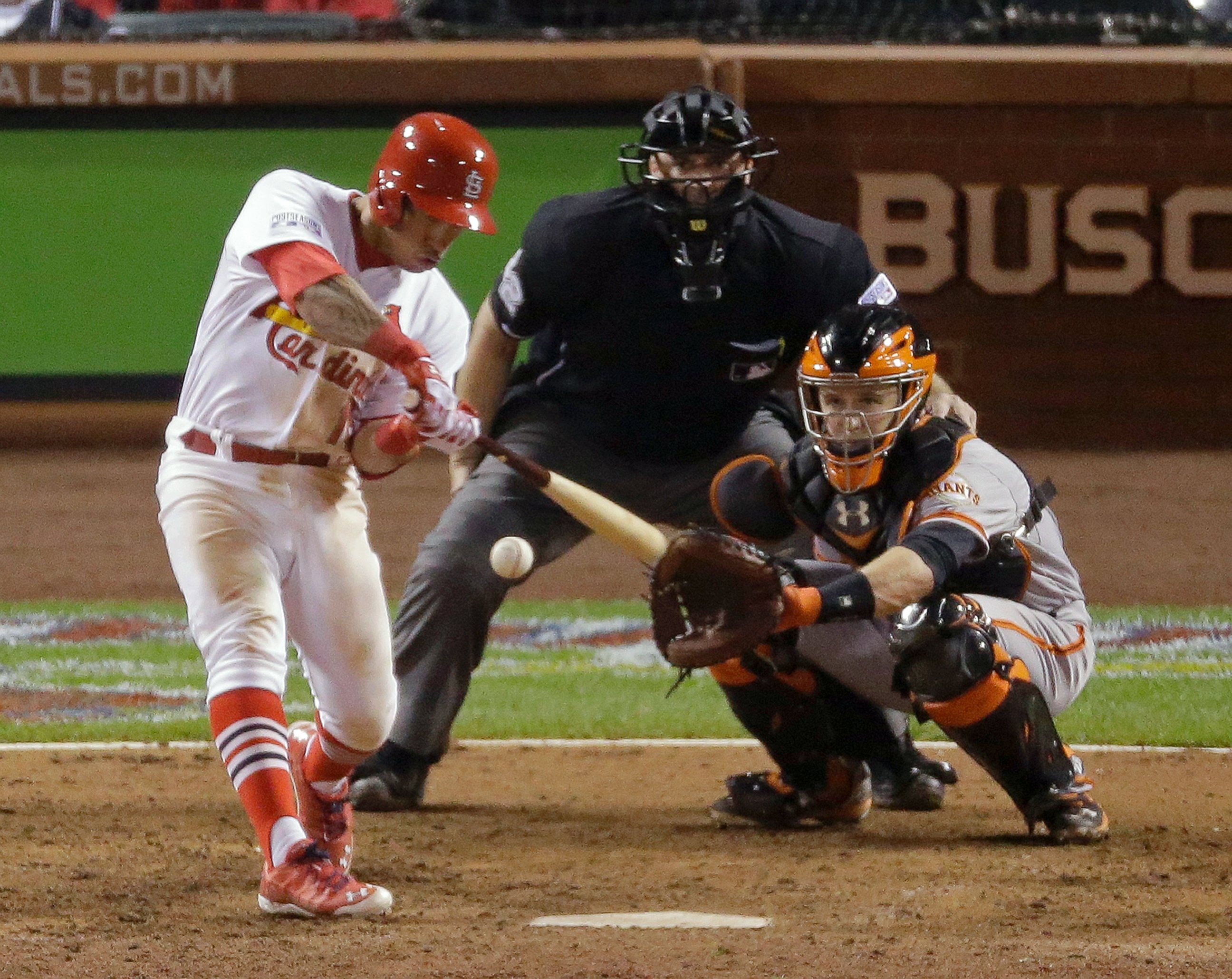PHOTO: St. Louis Cardinals' Kolten Wong hits a walk off home run during the ninth inning in Game 2 of the National League baseball championship series against the San Francisco Giants, Oct. 12, 2014, in St. Louis.