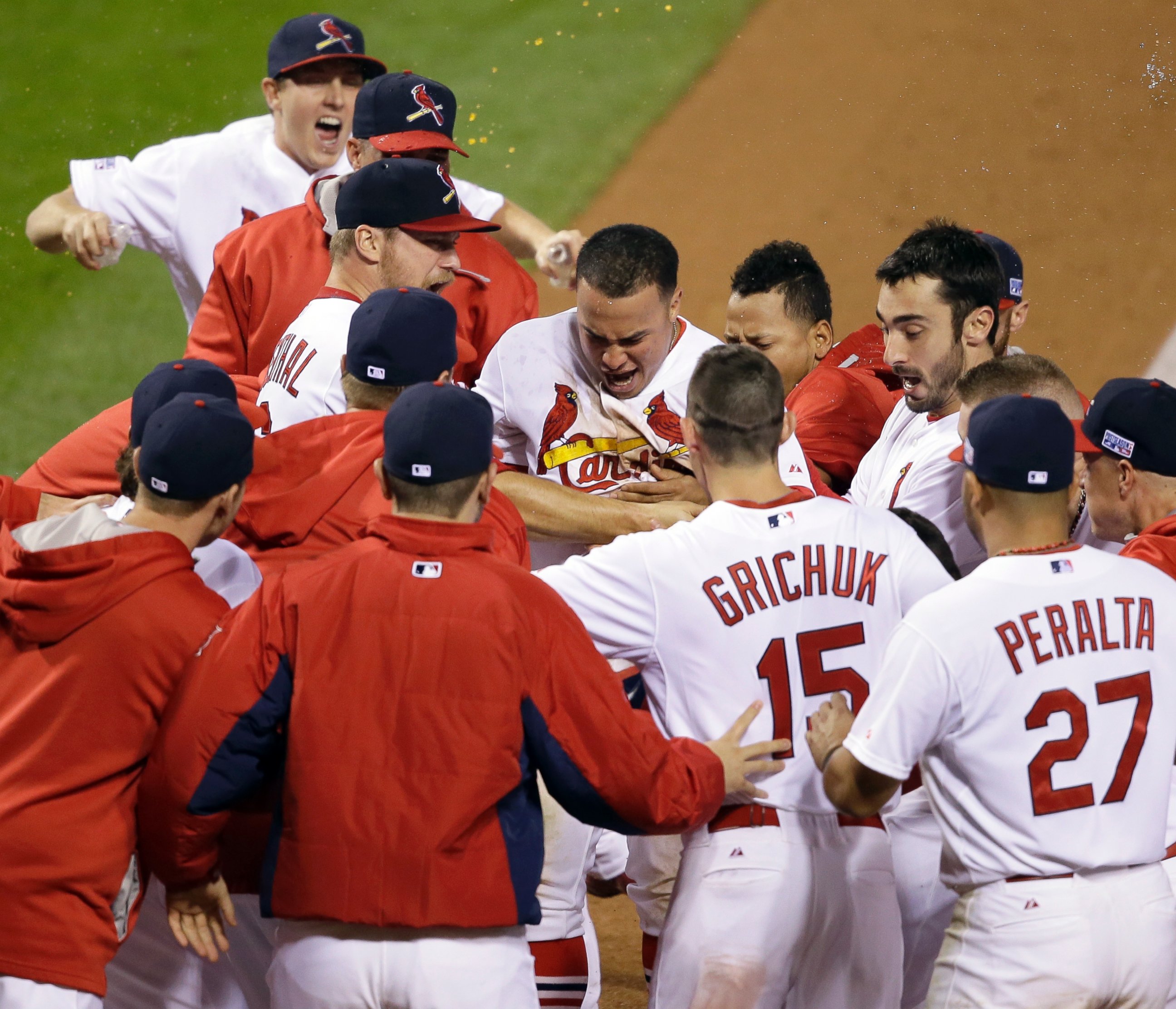PHOTO: St. Louis Cardinals' Kolten Wong is congratulated after hitting a walk off home run during the ninth inning in Game 2 of the National League baseball championship series, Oct. 12, 2014, in St. Louis.