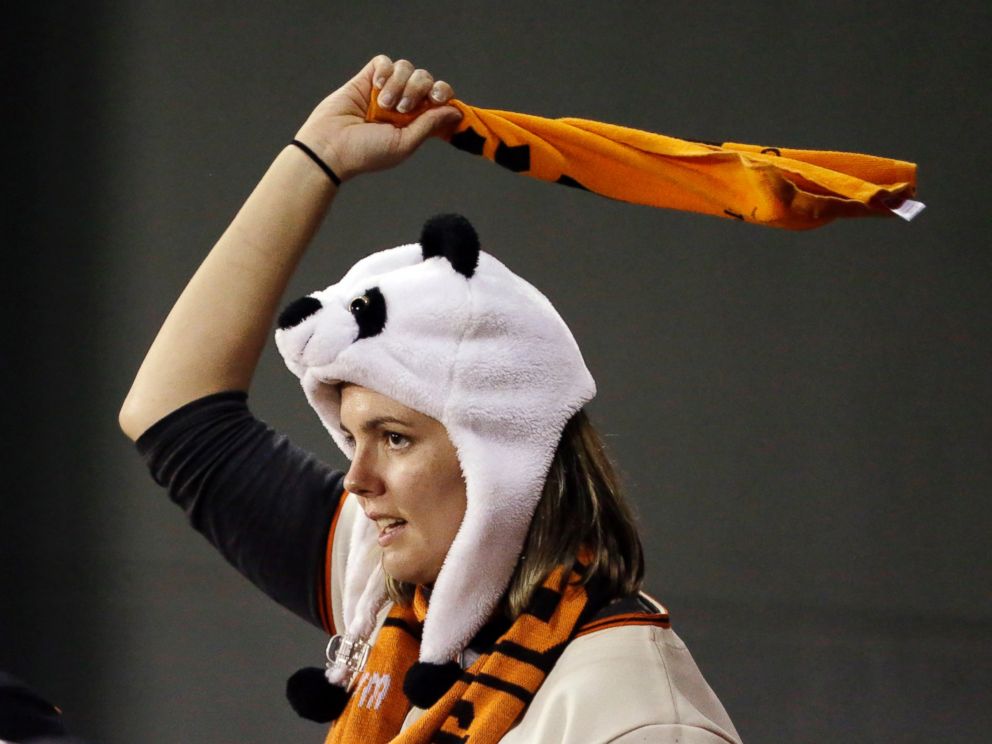 A fan cheers during the ninth inning of Game 5 of baseball's World Series between the Kansas City Royals and the San Francisco Giants, Oct. 26, 2014, in San Francisco.