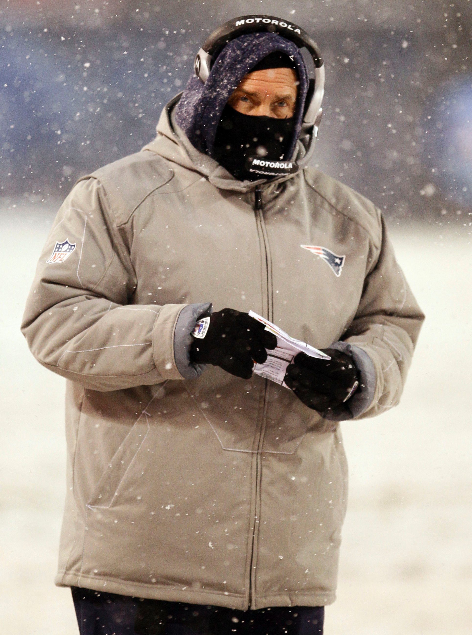 PHOTO: New England Patriots head coach Bill Belichick watches his team in the first half of an NFL football game in the snow against the Chicago Bears in Chicago on Dec. 12, 2010. 