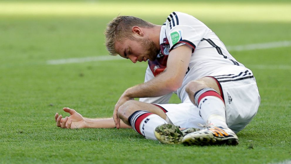 Germany's Christoph Kramer lies on the pitch after getting hit in the face by Argentina's Ezequiel Garay's shoulder during the World Cup final soccer match between Germany and Argentina at the Maracana Stadium in Rio de Janeiro, July 13, 2014.