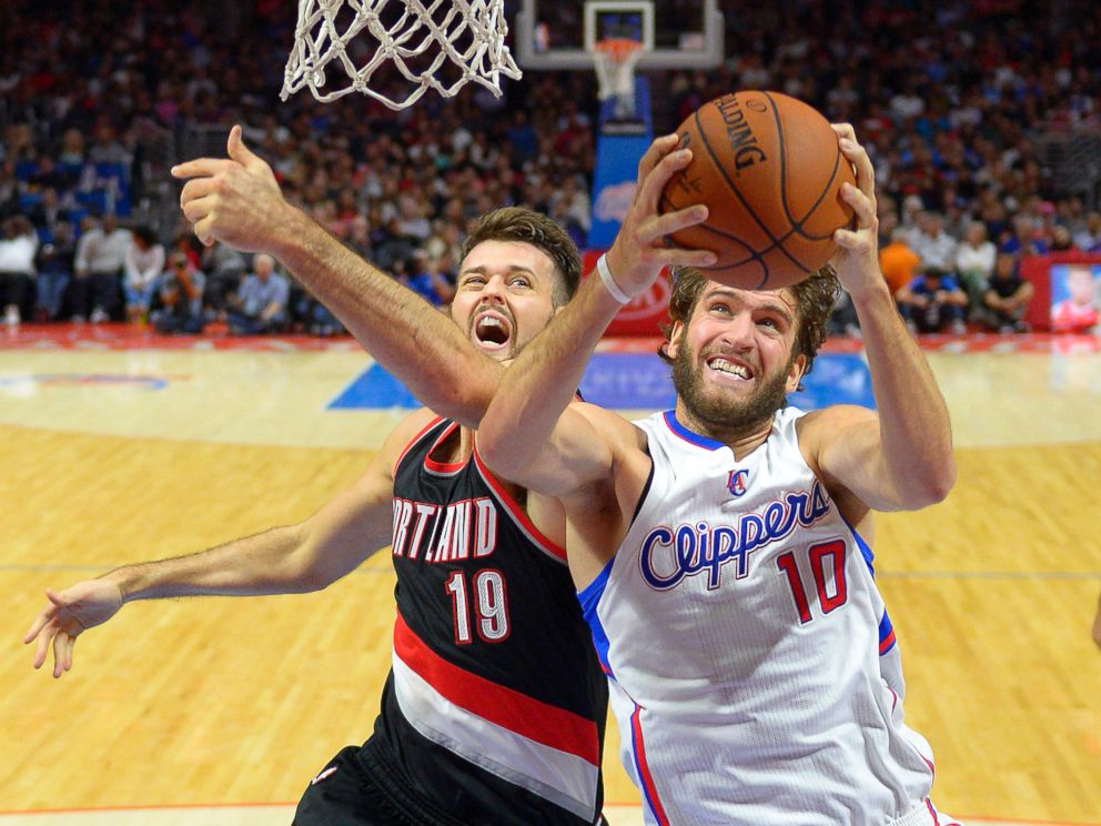 PHOTO: Los Angeles Clippers forward Spencer Hawes, right, goes to the basket as Portland Trail Blazers center Joel Freeland, of England, defends during the second half of a preseason NBA basketball game Oct. 24, 2014, in Los Angeles. 
