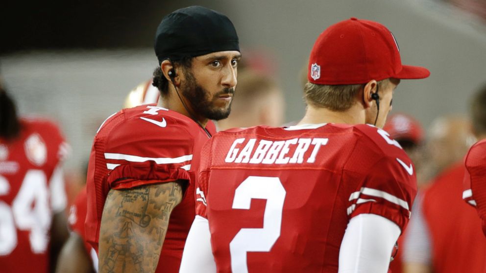 San Francisco 49ers quarterbacks Colin Kaepernick, left, and Blaine Gabbert stand on the sideline during the second half of an NFL preseason football game against the Green Bay Packers, Aug. 26, 2016, in Santa Clara, California. 